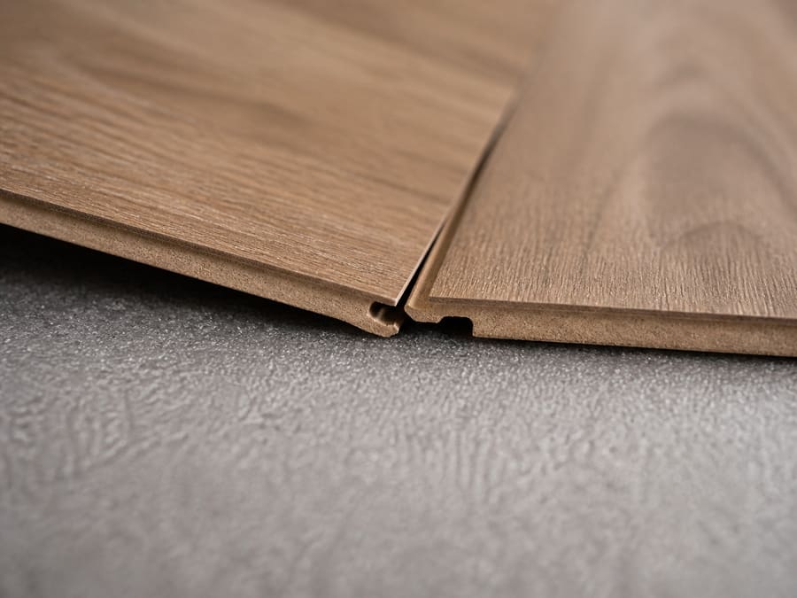 Close view of two laminate planks locking together over grey foam underlay